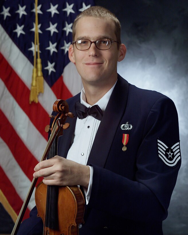 The men and women of The U.S. Air Force Band congratulate Technical Sgt. Luke Wedge as the recipient of the Colonel Finley R. Hamilton Outstanding Military Musician Award.