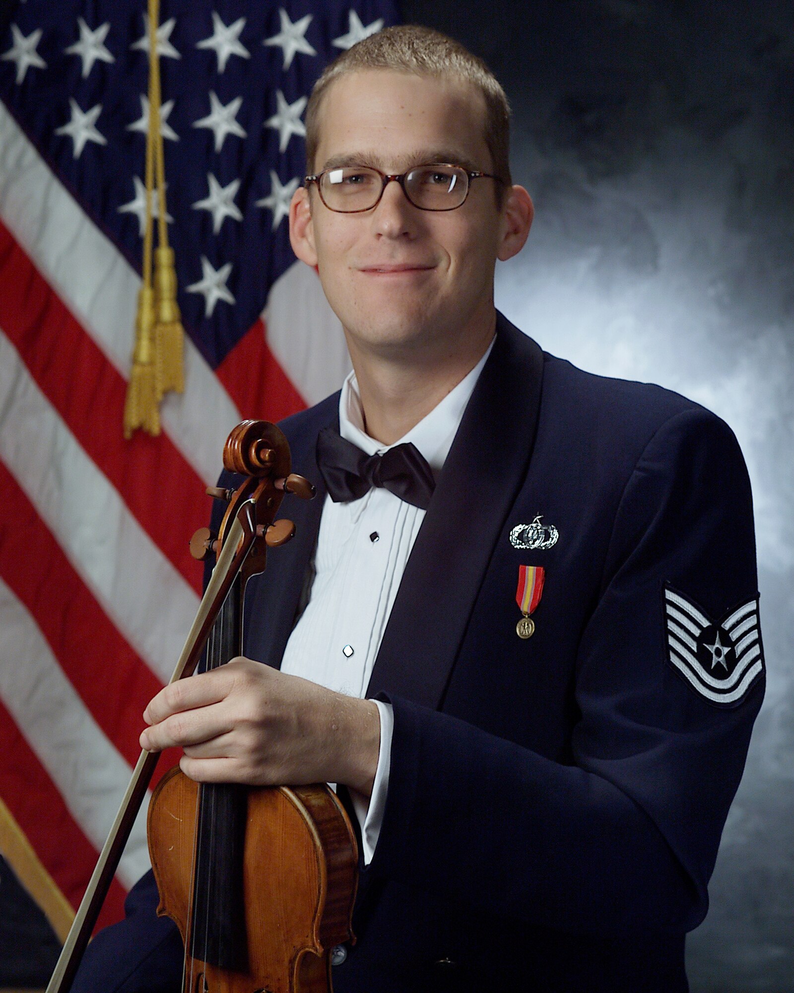 The men and women of The U.S. Air Force Band congratulate Technical Sgt. Luke Wedge as the recipient of the Colonel Finley R. Hamilton Outstanding Military Musician Award.