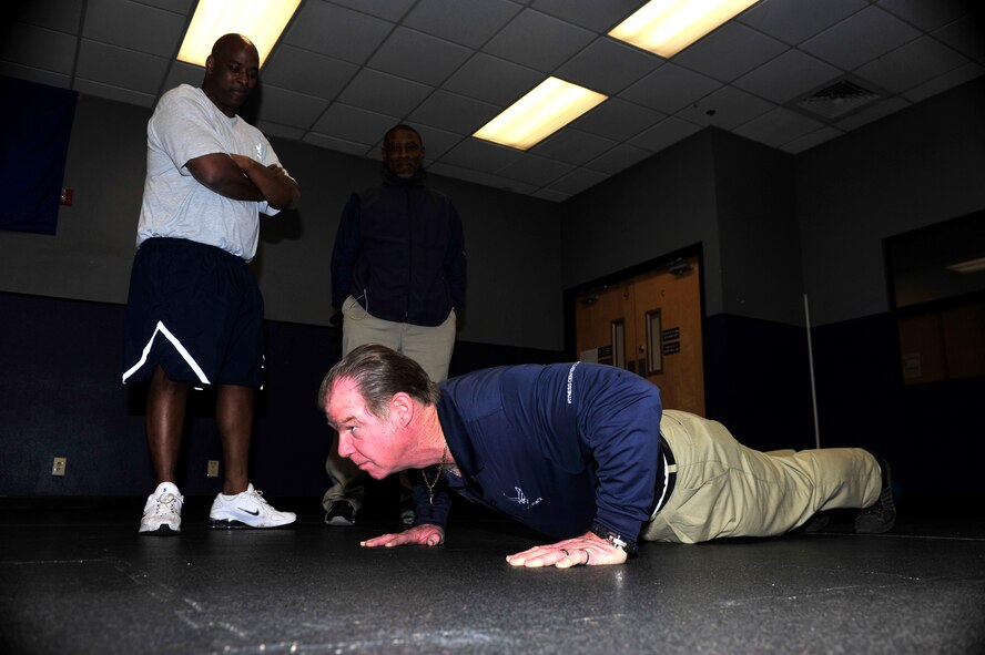 Michael Hunt, 56th Force Support Squadron fitness assessment technician, demonstrates a proper pushup Jan. 8 at Luke Air Force Base. The Air Force physical fitness assessment requires males and females to perform a number of proper pushups in one minute to prove their fitness level. (U.S. Air Force photo/Staff Sgt. Jason Colbert)