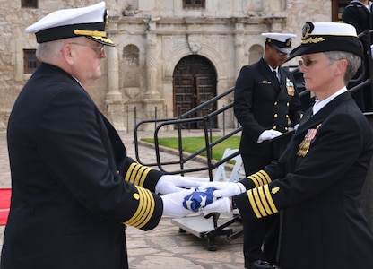 Capt. Lori S. Frank passes the flag to Capt. John D. Larnerd during his retirement ceremony Jan. 11 at the Alamo. Larnerd retired after more than 35 years of service.
Photo by Lori A. Newman