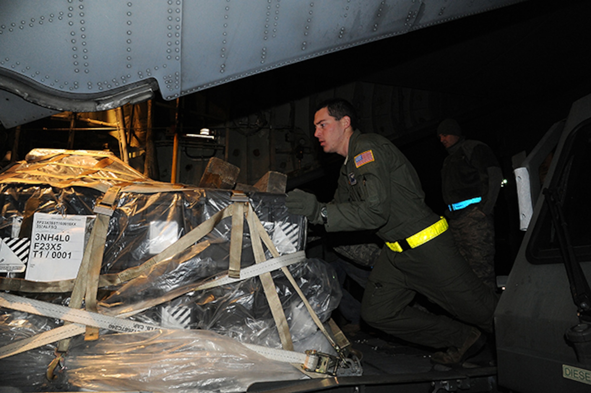 Senior Airman Nathan Basham helps load a pallet aboard a C-130. (Air Force photo by Lt. Col. Jerry Lobb)