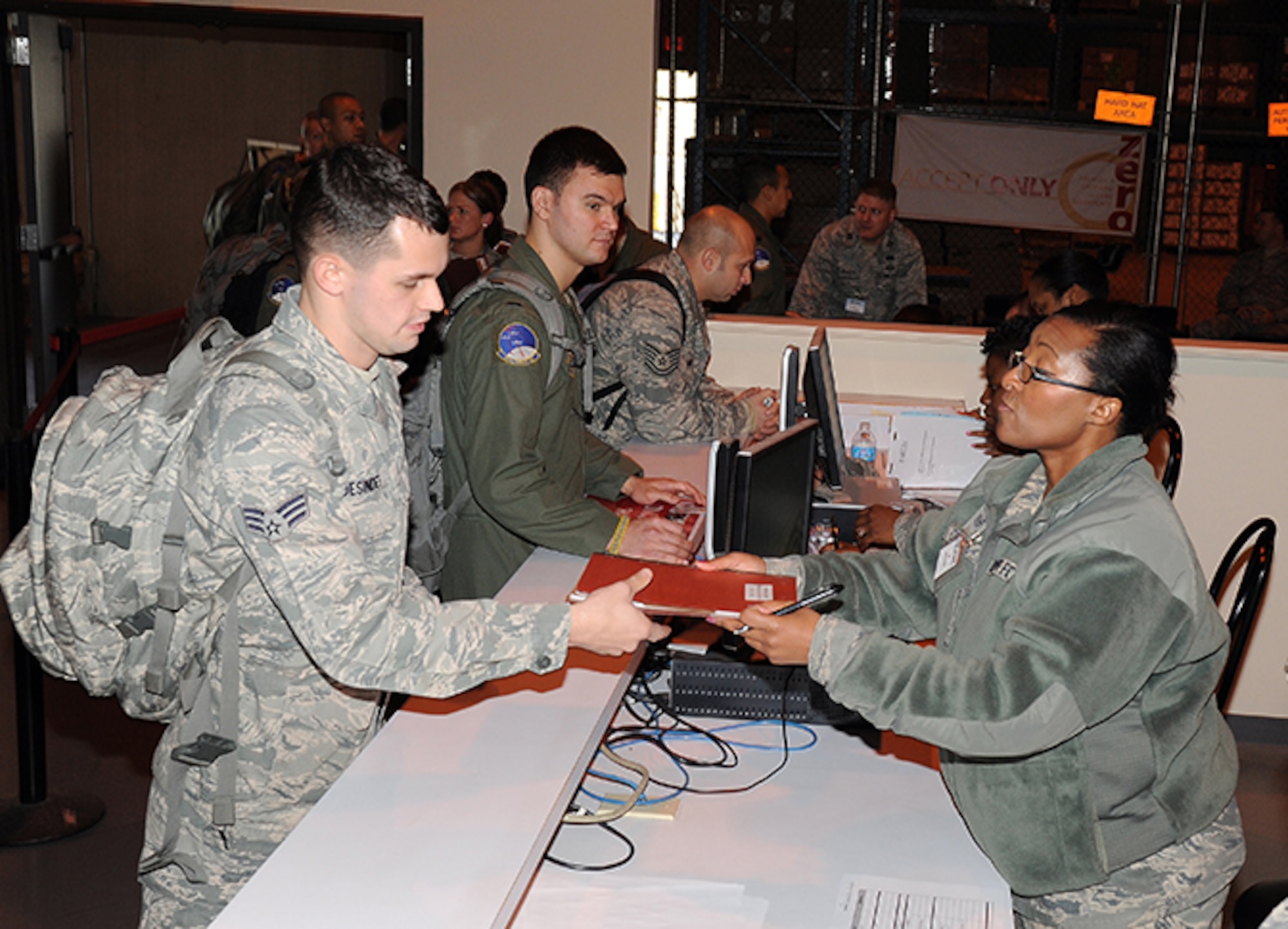 Senior Airman Ivan Desindes outprocesses with Tech. Sgt. Katrina George prior to deployment to Southwest Asia (Air Force photo by Lt. Col. Jerry Lobb)
