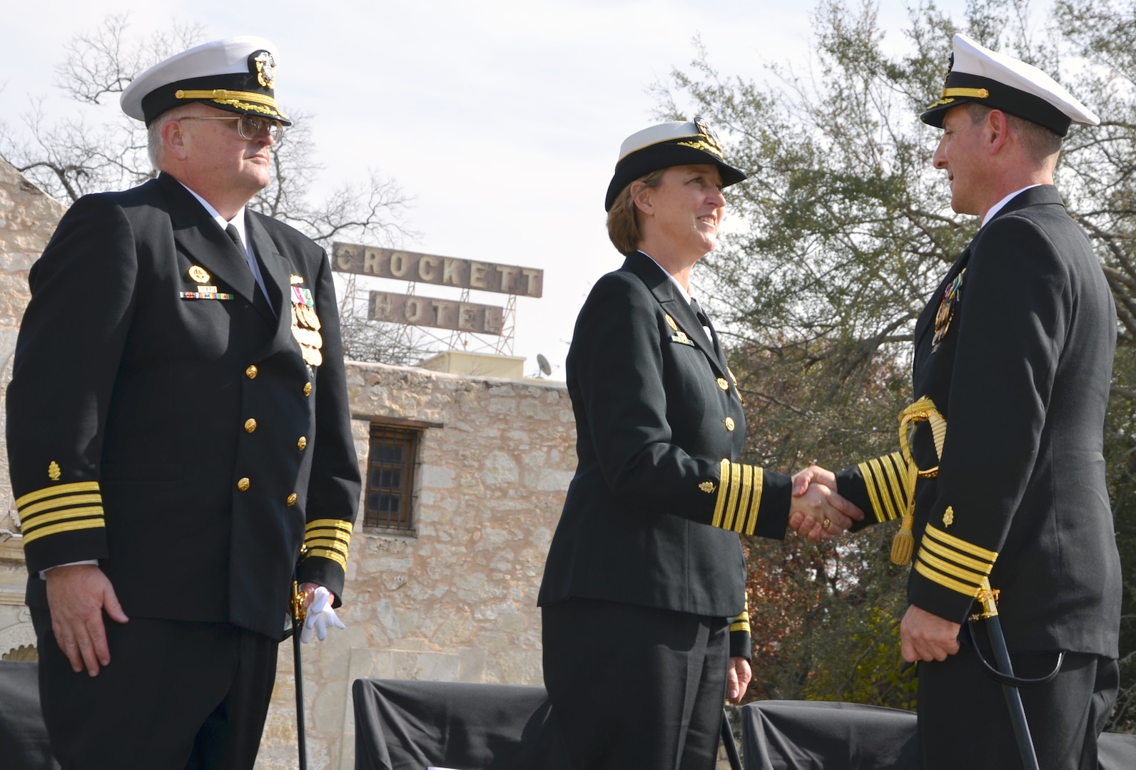 Navy Capt. Gail L. Hathaway, commander, Navy Medicine Education and Training Command, congratulates Capt. Joel A. Roos (right), new commander of Navy Medicine Training Support Center during a change of command ceremony Jan. 11 at the Alamo. Capt. John D. Larnerd (left) relinquished command to Roos.
Photo by Lori Newman