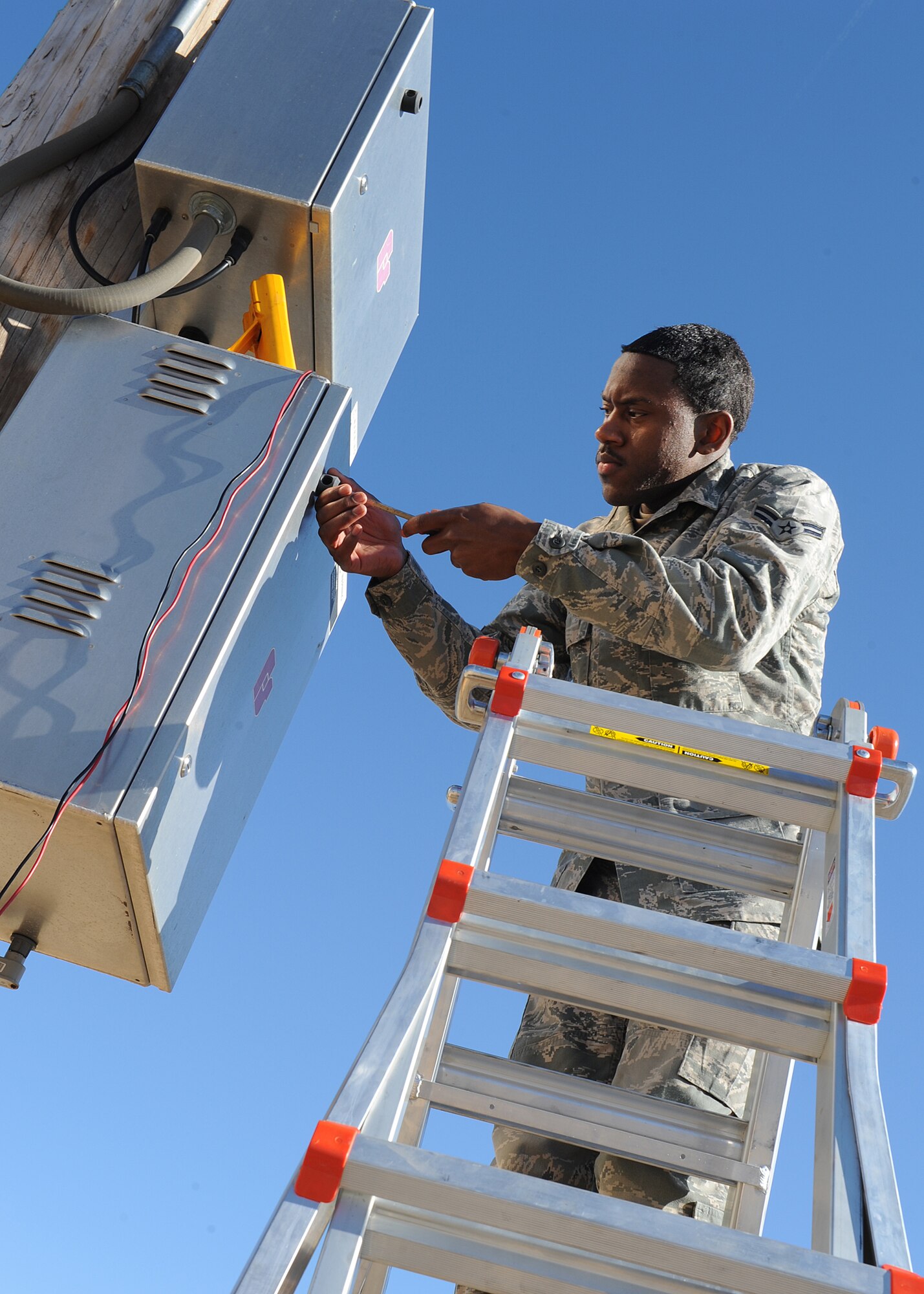 Airman 1st Class Vidal Pleasant, 22nd Communications Squadron radio frequency transmission systems technician, opens the container that holds the battery for the base’s mass notification system Jan. 17, 2013, McConnell Air Force Base, Kan. Pleasant was selected as the spotlight performer for the week of Jan. 14 to 18. (U.S. Air Force photo/Senior Airman Katrina M. Brisbin)