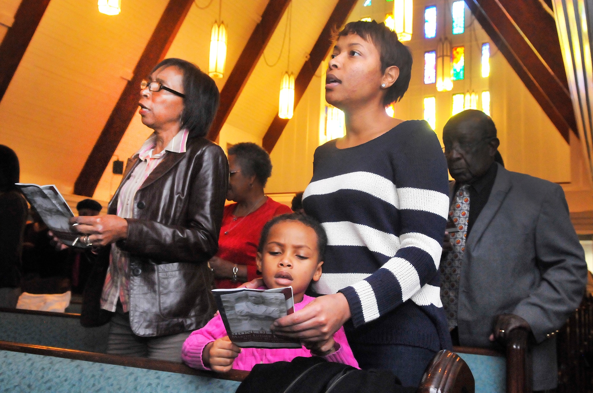 Carolyn, Tshunta, and Sydney Grace Rambert, sing "Lift Every Voice and Sing" at the Dr. Martin Luther King, Jr. commemorative service, "Celebrating Diversity in the Legacy of Dr. King", Jan. 17 at Robins Chapel. (U. S. Air Force photo/Sue Sapp)