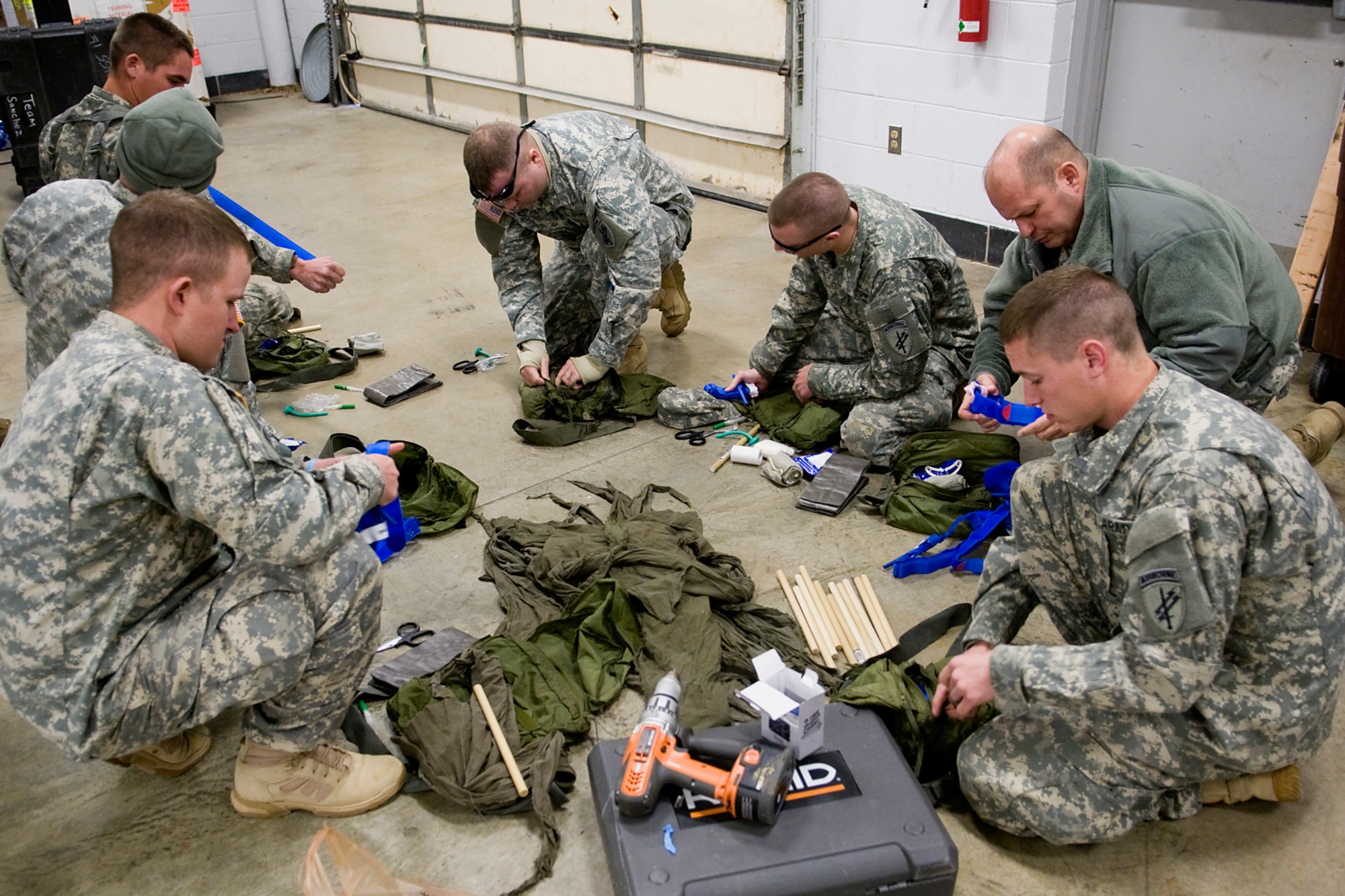 GRISSOM AIR RESERVE BASE, Ind. -- Soldiers of the 316th Psychological Operations Company, a tenant unit at Grissom, ready their gear prior to completing a tactical combat casualty care course as part of their combat lifesavers predeployment training. The 316th PSYOP Co. went through more than a month of predeployment training, including the CLS course, prior to deploying to the Horn of Africa in support of Operation Enduring Freedom.  (U.S. Air Force photo/Tech. Sgt. Mark R. W. Orders-Woempner)
