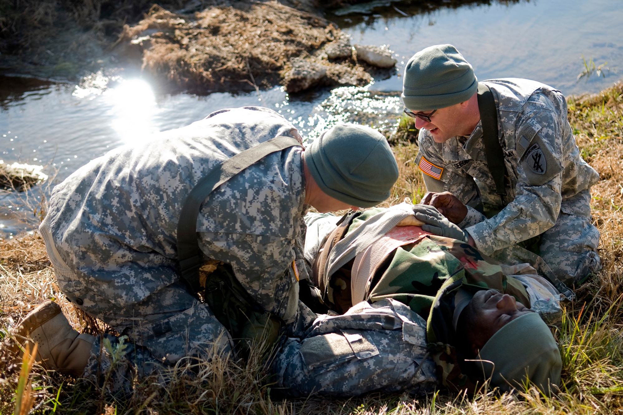 GRISSOM AIR RESERVE BASE, Ind. -- U.S. Army Reserve Pvt. 1st Class Michael Klingsmith, left, and Sgt. First Class Warren Seegers attend to simulated wounds of Staff Sgt. James Sterling during a tactical combat casualty care course here recently. The three Soldiers are assigned to the 316th Psychological Operations Company and participated in a combat lifesavers class as predeployment training. (U.S. Air Force photo/Tech. Sgt. Mark R. W. Orders-Woempner)
