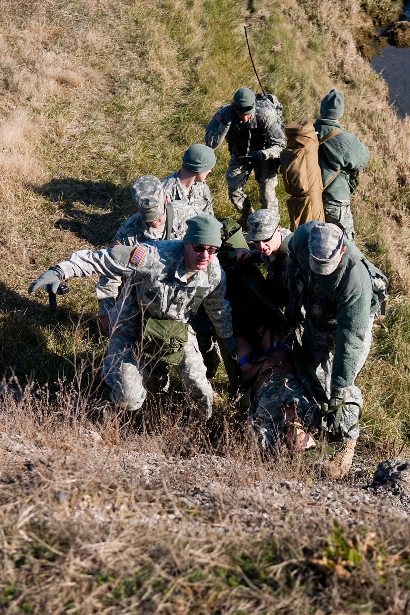 GRISSOM AIR RESERVE BASE, Ind. -- Soldiers for the Army Reserve's 316th Psychological Operations Company here carry a fellow psychological operations Soldier with simulated wounds out of a ditch during a combat lifesavers course held here. The 316th PSYOP Co. went through more than a month of predeployment training, including the CLS course, prior to deploying to the Horn of Africa in support of Operation Enduring Freedom.  (U.S. Air Force photo/Tech. Sgt. Mark R. W. Orders-Woempner)
