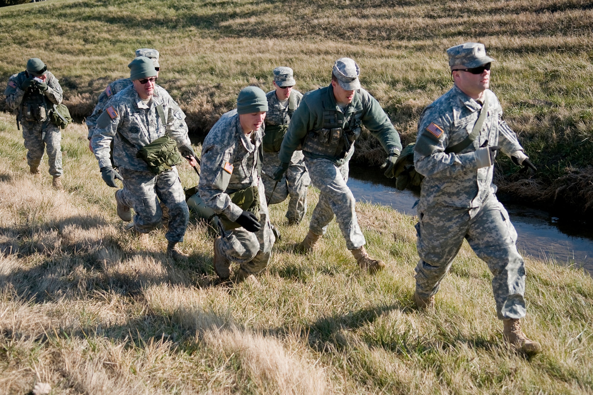 GRISSOM AIR RESERVE BASE, Ind. -- Soldiers for the Army Reserve's 316th Psychological Operations Company here transport a fellow psychological operations Soldier with simulated wounds during a combat lifesavers course held here. The 316th PSYOP Co. went through more than a month of predeployment training, including the CLS course, prior to deploying to the Horn of Africa in support of Operation Enduring Freedom.  (U.S. Air Force photo/Tech. Sgt. Mark R. W. Orders-Woempner)
