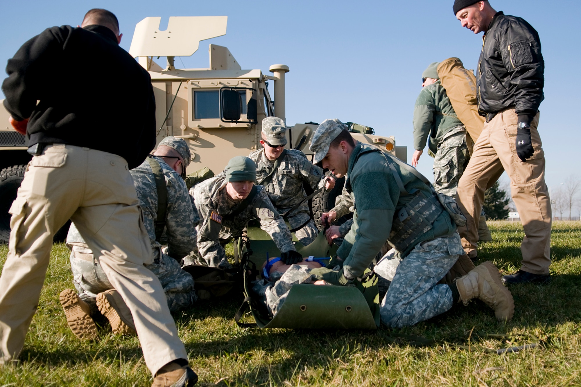 GRISSOM AIR RESERVE BASE, Ind. -- Garry Floyd, left, and Brian Bush, right, add stress and pressure to combat lifesaver course students from the U.S. Army Reserve's 316th Psychological Operations Company here during a recent predeployment training. Both are contract CLS instructors with a Florida-based company that provide CLS training to Soldiers around the country. (U.S. Air Force photo/Tech. Sgt. Mark R. W. Orders-Woempner)

