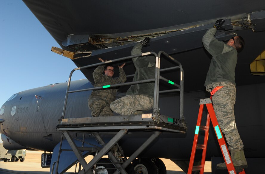 Airmen from the 2nd Aircraft Maintenance Squadron install a center fairing on a B-52H Stratofortress on Barksdale Air Force Base, La., Jan. 17. The center fairing covers cables and holds the pylon that carries weapons in place. (U.S. Air Force photo/Airman 1st Class Benjamin Gonsier)