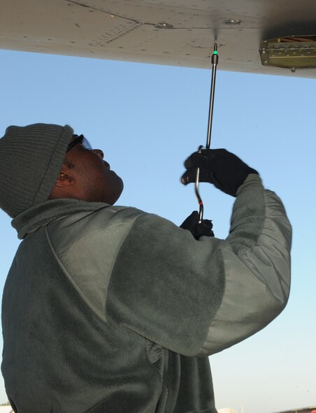 Staff Sgt. Kevin Edwards, 2nd Aircraft Maintenance Squadron weapons, removes a screw from a panel on a B-52H Stratofortress on Barksdale Air Force Base, La., Jan. 17. Edwards ensured the B-52 was ready to have an ALE-25 installed. The ALE-25 is the interface between the LITENING Pod and aircraft. The pods help aircrews verify targets, communicate with controllers and direct laser guided munitions. (U.S. Air Force photo/Airman 1st Class Benjamin Gonsier)