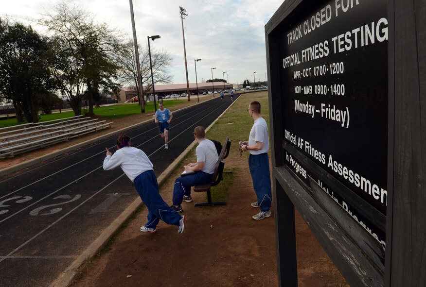 U.S. Air Force Staff Sgt. Julie Walker, Air Forces Central coastal operations manager, encourages Airmen during the mile and a half run portion of the physical training evaluation at Shaw Air Force Base, S.C., Jan. 16, 2013. Since October 2012, military members have taken over conducting physical training tests. (U.S. Air Force photo taken by Senior Airman Tabatha Zarrella/released)