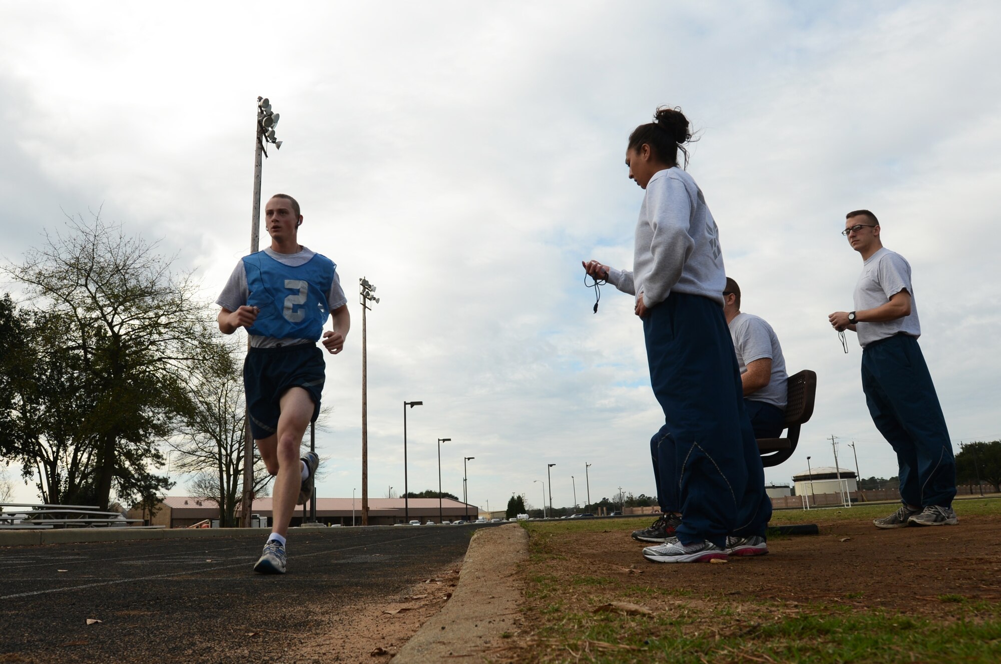 U.S. Air Force Staff Sgt. Julie Walker, Air Forces Central coastal operations manager, speaks out the time to Airman 1st Class Colin Hundt, 20th Civil Engineer Squadron entomologist, during the sit-up portion of the physical training evaluation at Shaw Air Force Base, S.C., Jan. 16, 2013. Since October 2012, military members have taken over conducting physical training tests. (U.S. Air Force photo taken by Senior Airman Tabatha Zarrella/released)