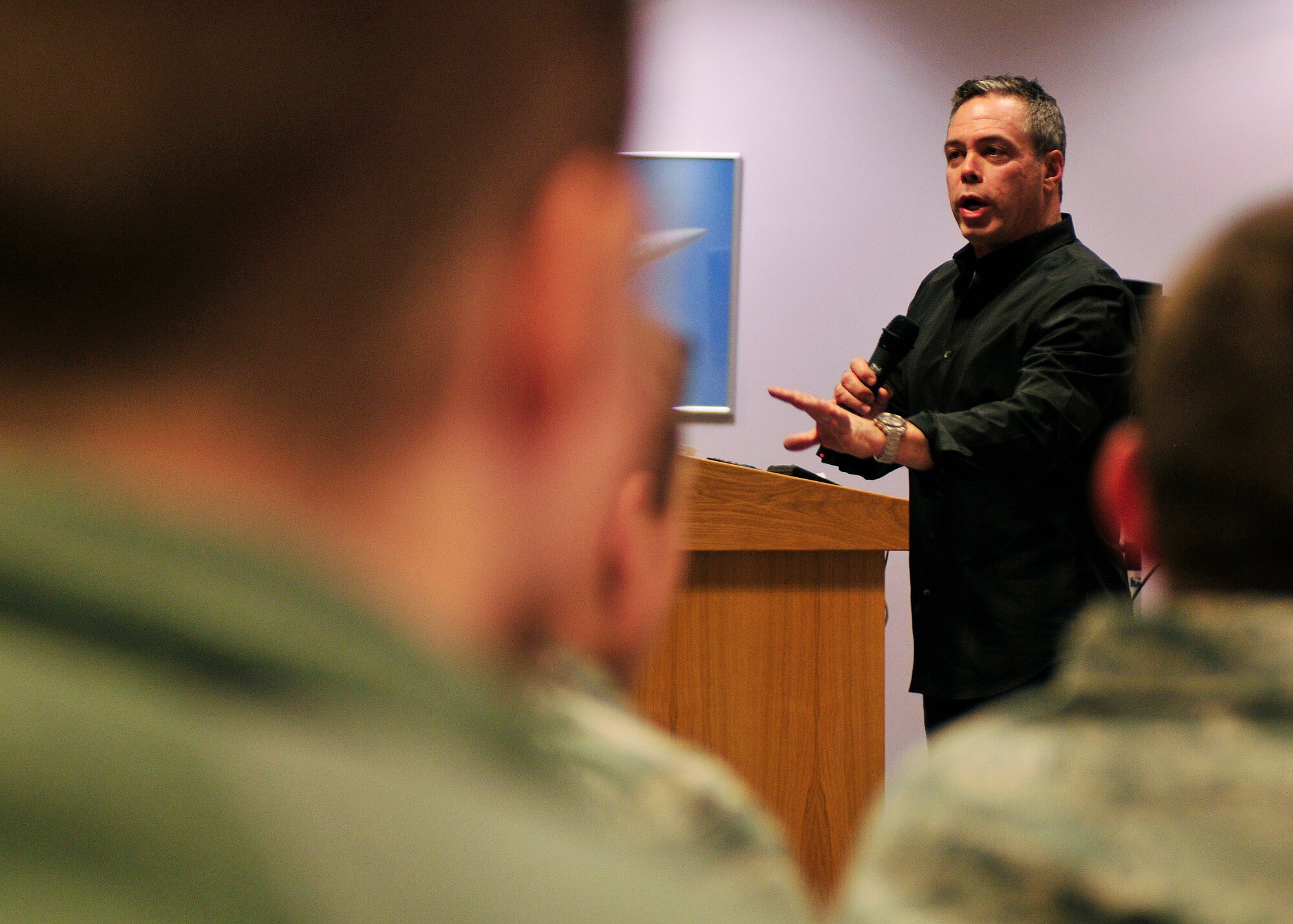 ROYAL AIR FORCE LAKENHEATH, England - Bernie McGrenahan, an American stand-up comedian, educates young Airmen on sexual assault and alcohol abuse prevention through humor Jan. 15, 2013. McGrenahan began his segment with light humor and finished with a personal testimony. (U.S. Air Force photo by Senior Airman Tiffany M. Grigg)