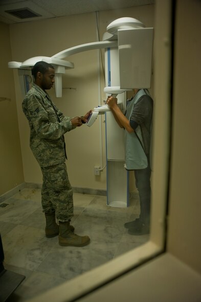 Senior Airman Kelvin Johnson, 39th Medical Operations Squadron dental assistant, prepares to perform an x-ray on a patient Jan. 16, 2013, at Incirlik Air Base, Turkey. The 39th MDOS clinic is responsible for cleaning all active duty members’ teeth at least once a year. (U.S. Air Force photo by Senior Airman Anthony Sanchelli/Released)