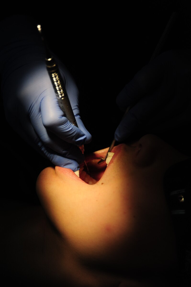 Senior Airman Megan Luscier, 39th Medical Operations Squadron dental technician, cleans teeth during a routine check-up Jan. 16, 2013, at Incirlik Air Base, Turkey. The base dental clinic performs annual cleaning on servicemembers and family members at Incirlik. (U.S. Air Force photo by Senior Airman Anthony Sanchelli/Released)