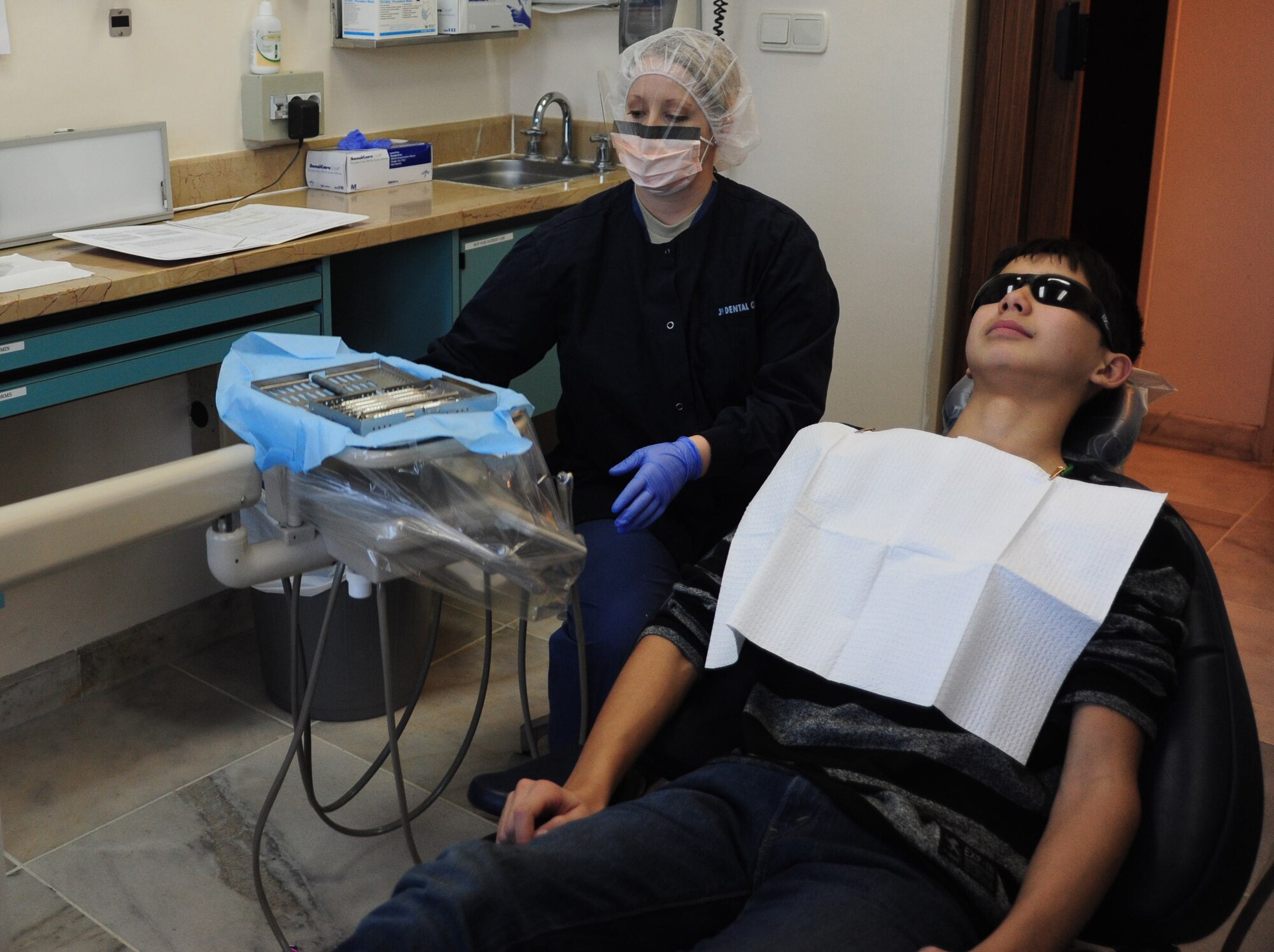 Senior Airman Megan Luscier, 39th Medical Operations Squadron dental technician, prepares for a teeth cleaning Jan. 16, 2013, at Incirlik Air Base, Turkey. The base dental clinic is responsible for active duty and family member dental care. (U.S. Air Force photo by Senior Airman Anthony Sanchelli/Released)