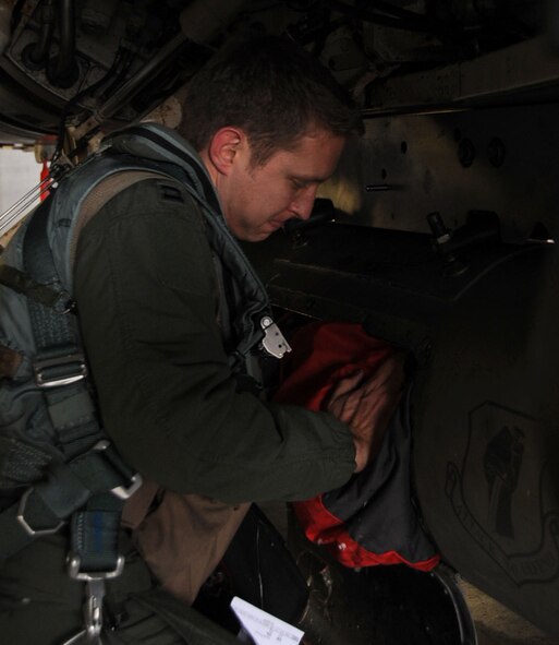 U.S. Air Force Capt. Nate Lightfoot, 13th Fighter Squadron pilot, stores his bags away in the carrier of an F-16 Fighting Falcon before leaving for Guam at Misawa Air Base, Japan, Jan. 18, 2013. The Aviation Training Relocation exercise allows pilots to rate how their aircraft fare against rivals. (U.S. Air Force photo by Airman 1st Class Kenna Jackson)