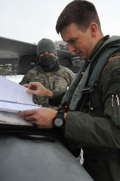 U.S. Air Force Capt. Scott Kotowski, 13th Fighter Squadron pilot, checks the maintenance logs for his F-16 Fighting Falcon before heading to Guam at Misawa Air Base, Japan, Jan. 18, 2013. The Aviation Training Relocation exercise is geared to enhance pilots’ and crew members’ combat skills. (U.S. Air Force photo by Airman 1st Class Kenna Jackson)