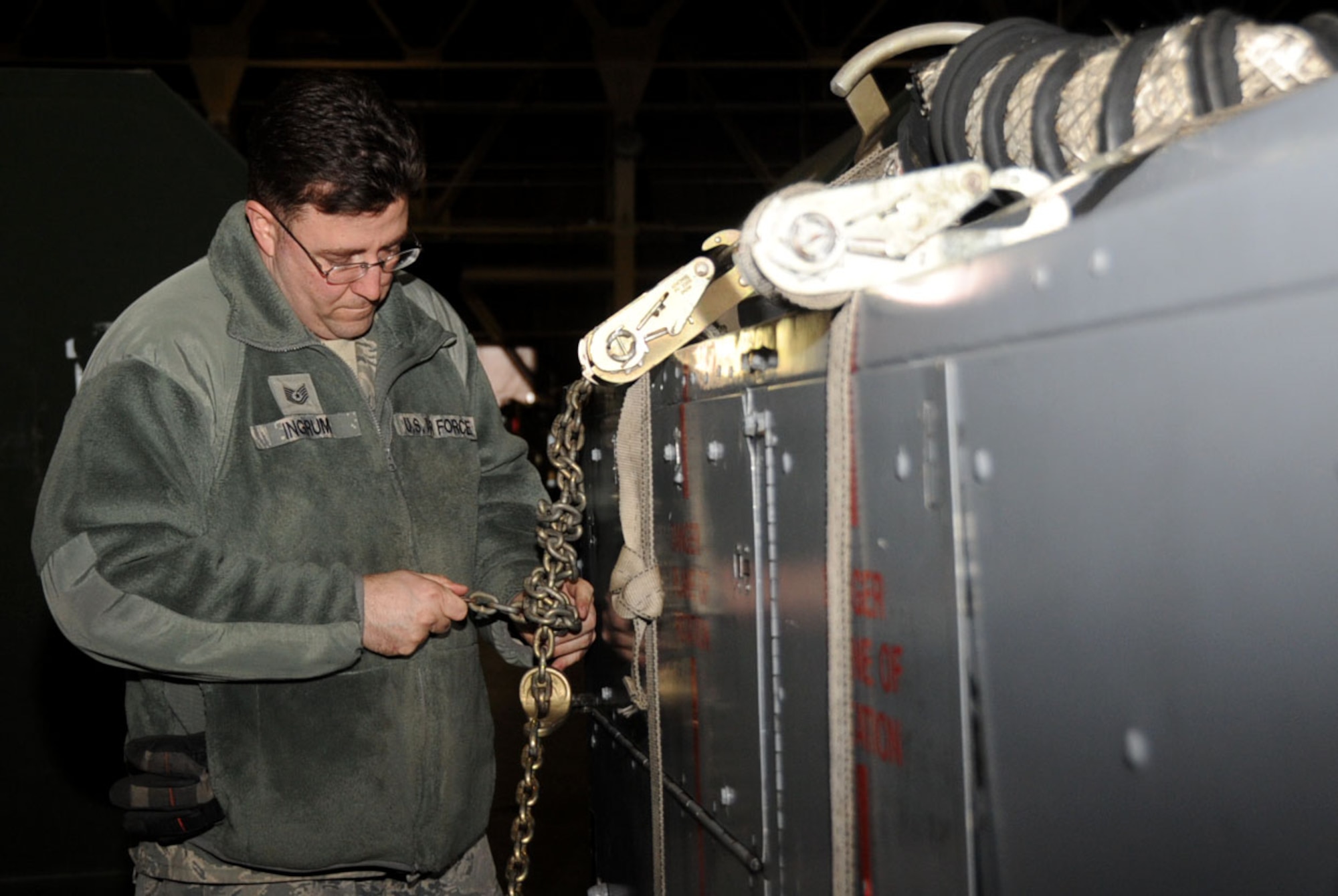 U.S. Air Force Tech. Sgt. Darrell Ingrum, 35th Maintenance Squadron support section NCO in charge, secures cargo at Misawa Air Base, Japan, Jan. 14, 2013. All equipment must be secure and accounted for before departure from the base. Over 68 tons of cargo was sent to Guam for pilot and crew members use during the Aviation Training Relocation Exercise. (U.S. Air Force photo by Airman 1st Class Kenna Jackson)