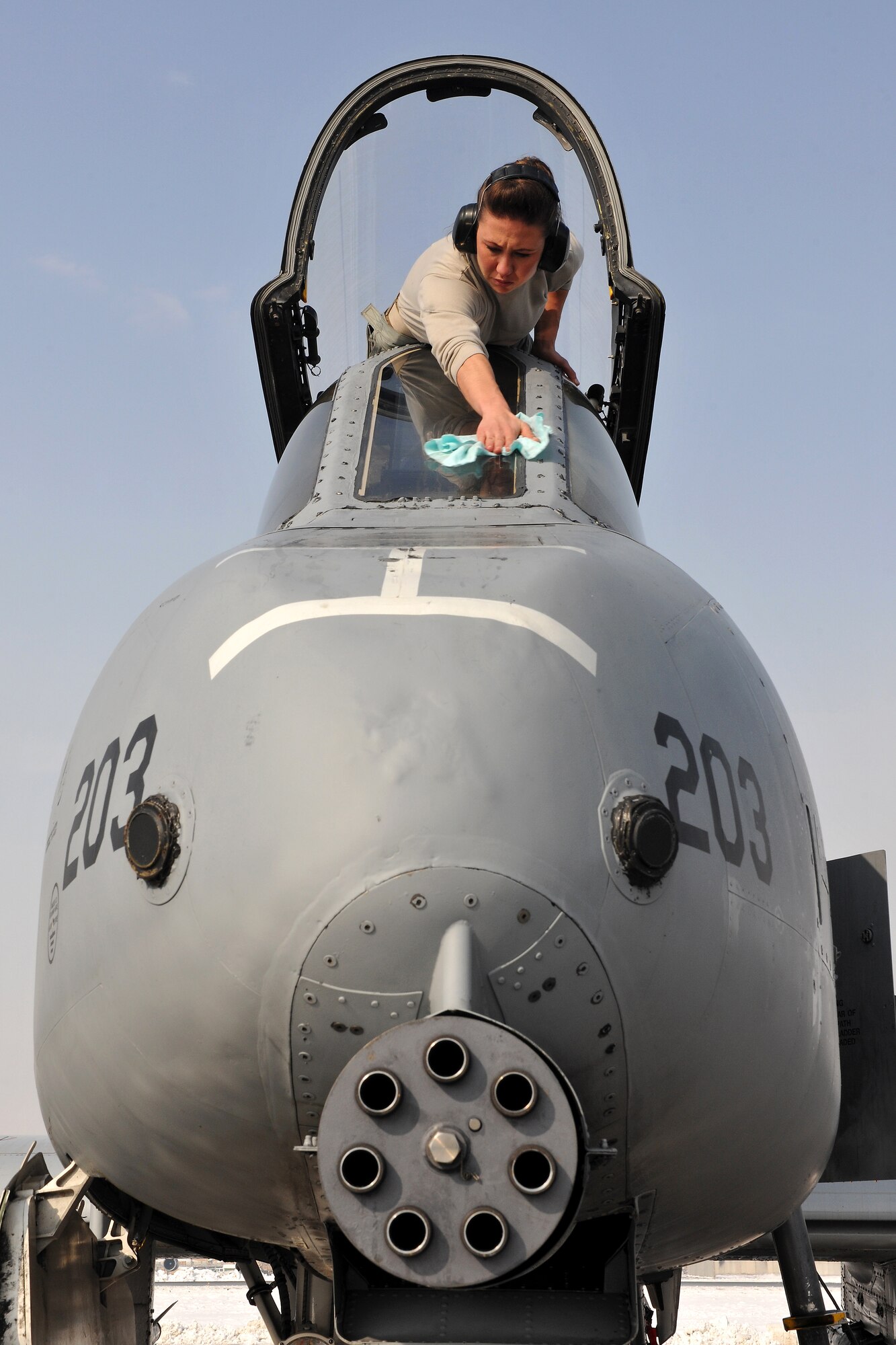 Staff Sgt. Miranda Downs, 455th Expeditionary Aircraft Maintenance Squadron, wipes snow off of an A-10 Thunderbolt II at Bagram Airfield, Afghanistan, Jan. 13, 2013. Downs is part of a team from 455th EAMXS that removed snow from the aircraft in preparation for its close air support mission. (U.S. Air Force photo/Senior Airman Chris Willis)