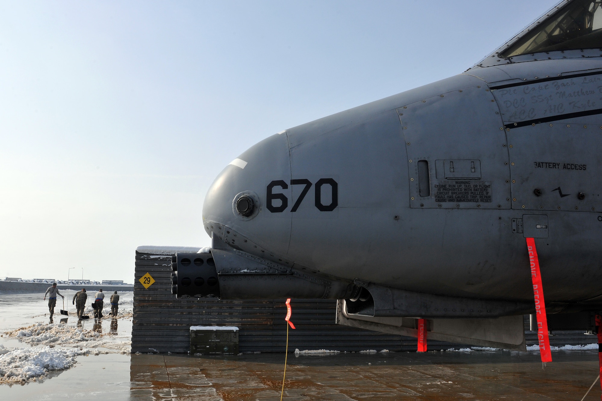 Members of the 455th Expeditionary Aircraft Maintenance Squadron clear snow around an A-10 Thunderbolt II at Bagram Airfield, Afghanistan, Jan. 13, 2013. Maintenance Airmen removed snow from the aircraft and flightline to minimize the possibility of damage prior to taxi and takeoff. (U.S. Air Force photo/Senior Airman Chris Willis)