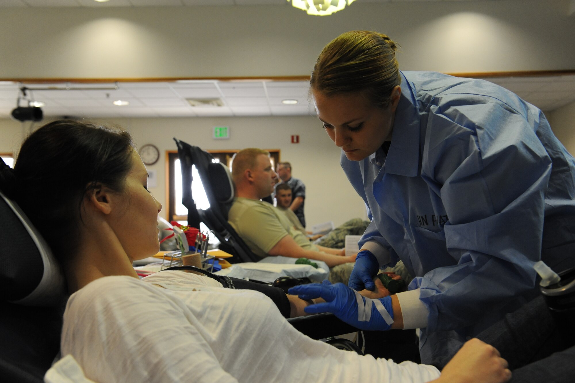 U.S. Navy Corpsman Leigh Prevatte, U.S. Armed Services Blood Bank corpsman, gets ready to draw blood from U. S. Air Force 1st Lt. Kristine Mosher, 18th Medical Group neonatal intensive care unit nurse, during the Martin Luther King Blood Drive on Kadena Air Base, Japan, Jan. 17, 2013. The blood drive was held to remember Martin Luther King Jr. and inform people about his impact on American history. The drive was also one of three events dedicated to remembering MLK. (U.S. Air Force photo/Airman 1st Class Malia Jenkins)
