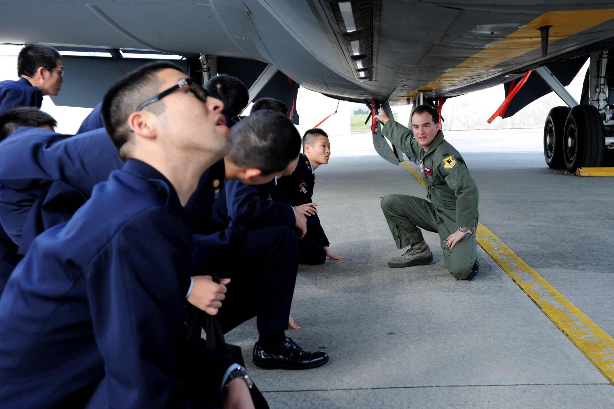 U.S. Air Force 1st Lt. Thomas Braxton, 909th Air Refueling Squadron pilot, explains the purpose behind lights underneath the KC-135 Stratotanker to Japan Air Self-Defense Force cadets on Kadena Air Base, Japan, Jan. 17, 2013. The KC-135 Stratotanker’s principal mission is air refueling and greatly enhances the Air Force’s capability to accomplish its primary missions of Global Reach and Global Power. JASDF members joined Braxton on the flightline and received a tour of the aircraft as part of their visit to Kadena. (U.S. Air Force photo/Airman 1st Class Hailey R. Davis)