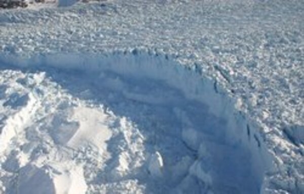 The calving front, or break-off point into the ocean, of Helheim Glacier, located in southeast Greenland, May 2005. This glacier is one of the fastest moving glaciers in the world. 