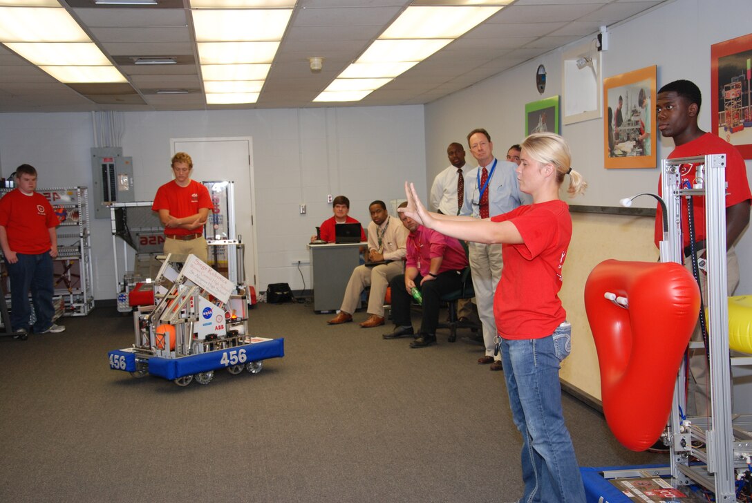 Robotics Student Kelsey McMaster gives Vicksburg-Warren School District administrators a demonstration of the team’s robot in the ERDC Science, Technology, Engineering, and Mathematics Center.