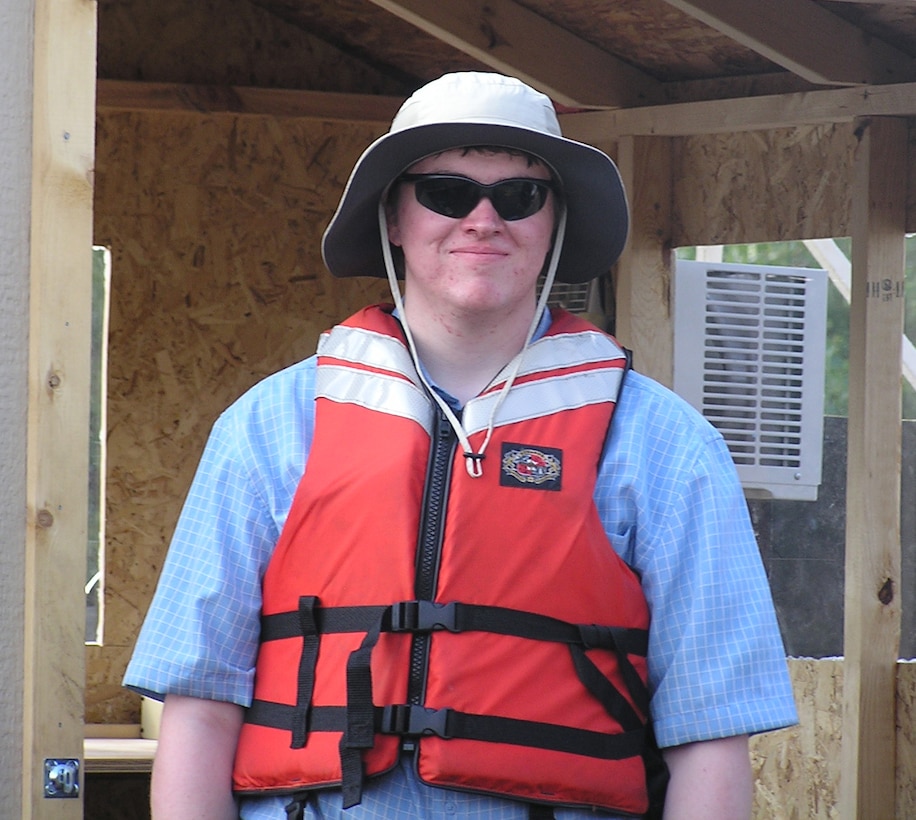 Ian McInerney, with the Student Temporary Employment Program, is ready for work at the fish barrier test site.