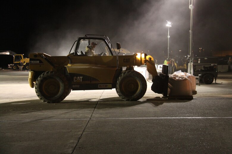 RED HORSE team member uses forklift to move fill materials used to fill craters during the demonstration.