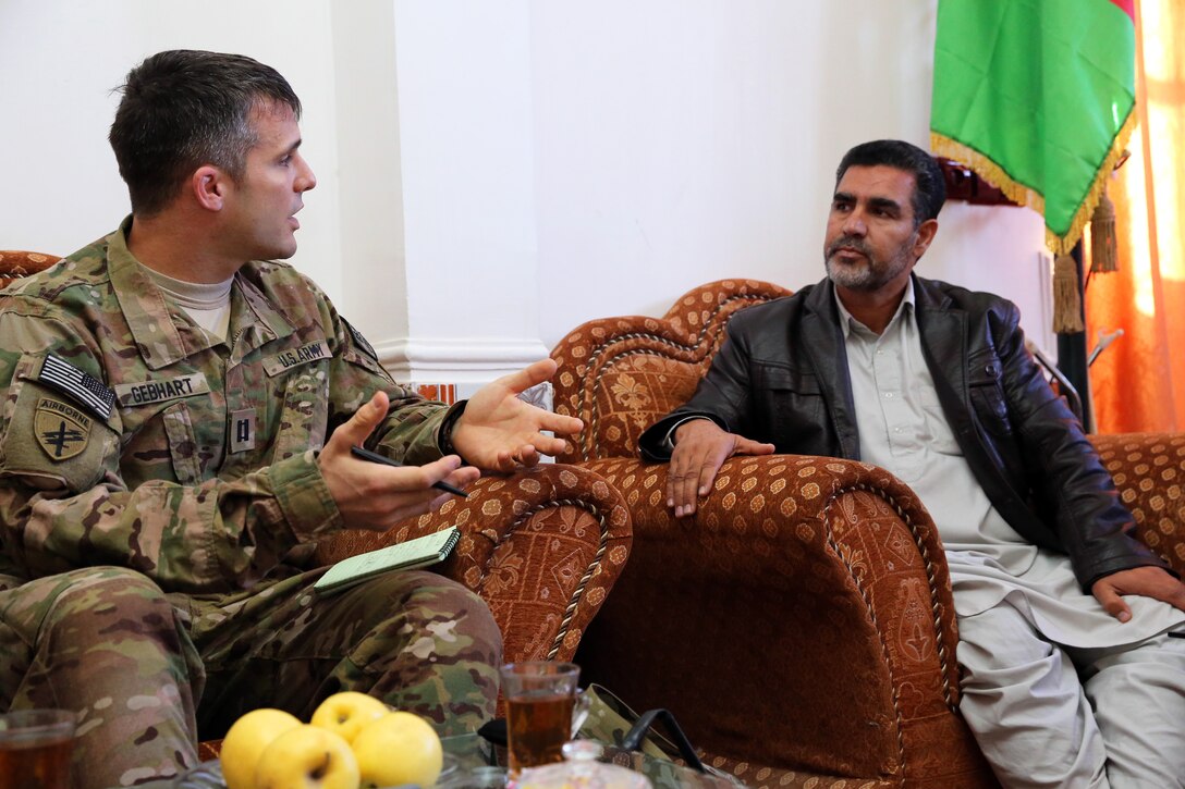 U.S. Army Capt. Jeremiah Gebhart, left, talks with Nasrullah Amini, director of labor and social affairs, during a leadership meeting in Farah City, Afghanistan, Jan. 17, 2013. Gebhart, a civil affairs officer, is assigned to Provincial Reconstruction Team Farah.