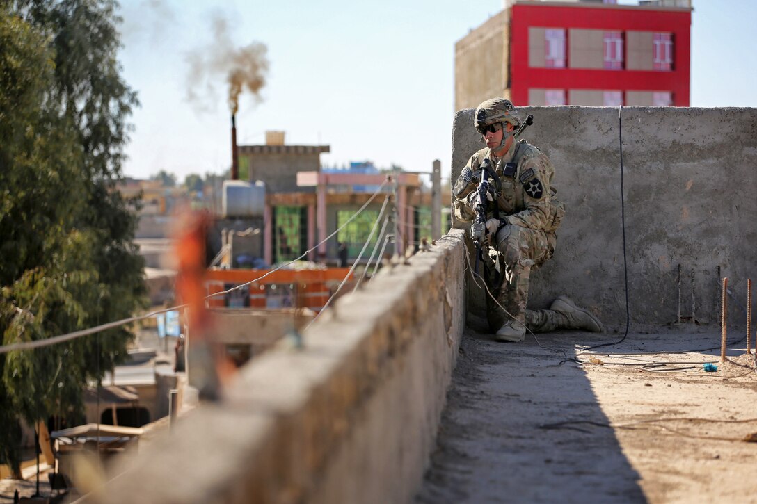 U.S. Army Spc. Joseph Gonzalez maintains security from the rooftop during a leadership meeting in Farah City, Afghanistan, Jan. 17, 2013. Gonzalez is assigned to Provincial Reconstruction Team Farah.