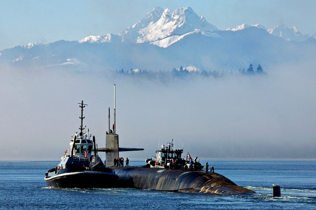 The ballistic missile submarine USS Henry M. Jackson transits past the Olympic Mountains as it prepares to conduct sea trials in Bangor, Wash., Jan. 16, 2013. 