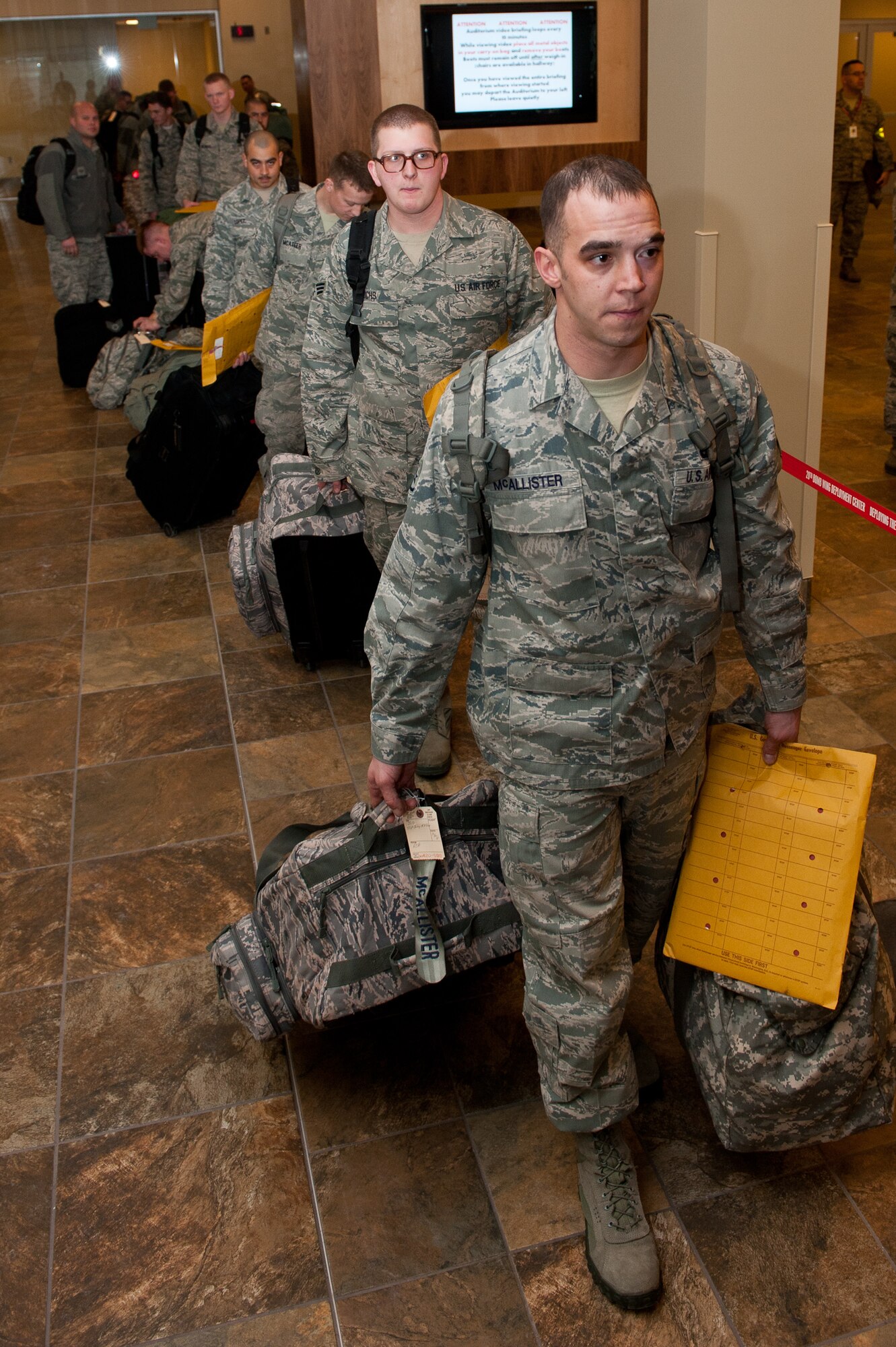 Airmen assigned to the 34th Bomb Squadron enter a deployment processing line at the Deployment Center on Ellsworth Air Force Base, S.D., Jan. 19, 2013. Approximately 350 Ellsworth Airmen are deploying to Southwest Asia to support missions in the U.S. Central Command area of responsibility. (U.S. Air Force photo by Airman 1st Class Kate Thornton-Maurer/ Released)