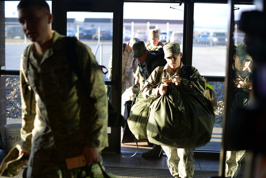 Ellsworth Airmen enter the deployment center at Ellsworth Air Force Base, S.D., Jan. 19, 2013. The Airmen will deploy to Southwest Asia and conduct B-1 missions designed to rapidly deliver precision and non-precision weapons against adversaries. (U.S. Air Force photo by Master Sgt. John Barton/Released)  