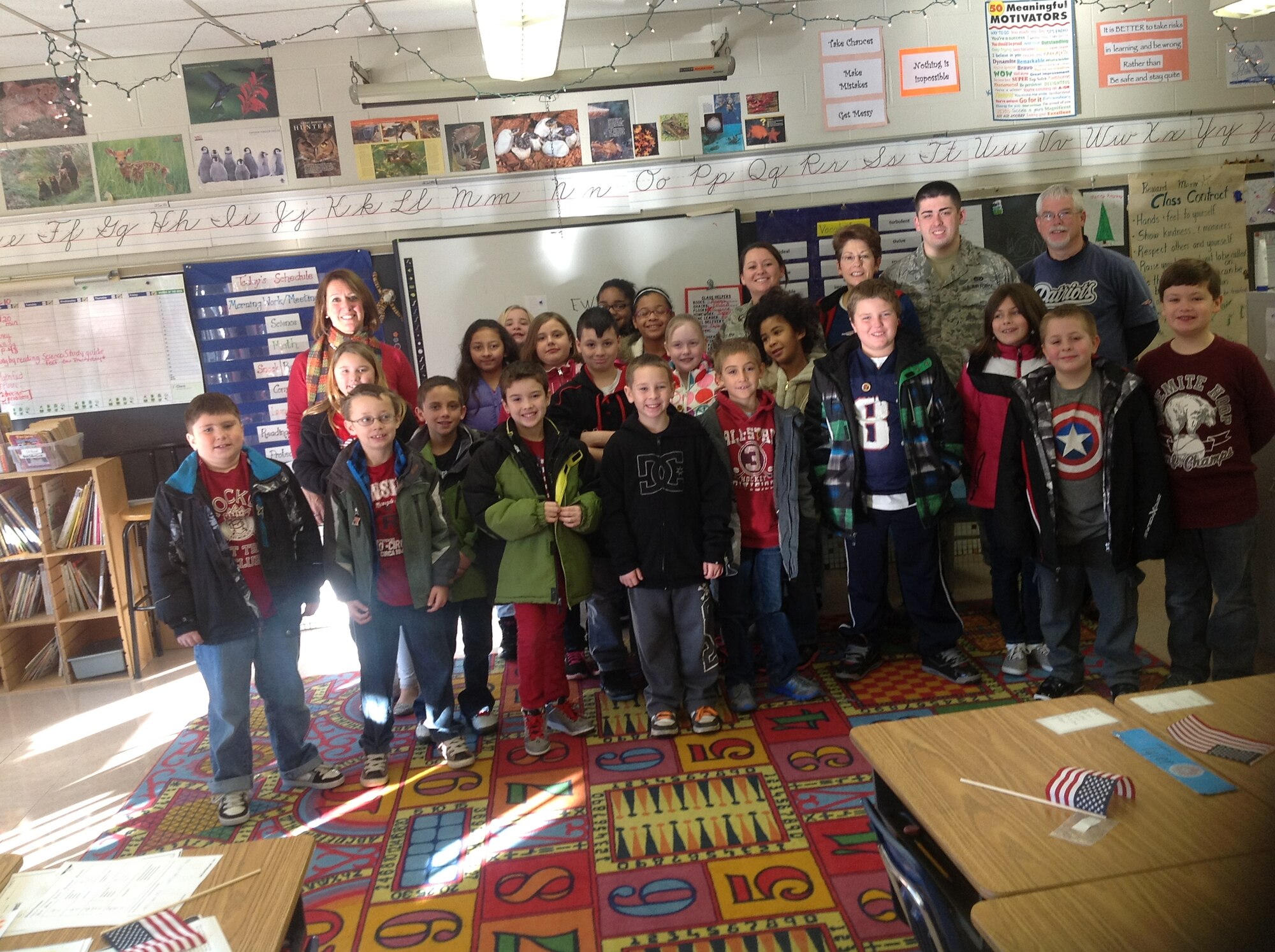 Staff Sgt. Jessica Roy and Senior Airman Kyle Roy visit with Mrs. Cerrato's class at Edgar H. Parkman School in Enfield, Conn. Dec. 11, 2012, before the start of a Wreaths Across America Ceremony hosted there to honor veterans. (Photo courtesy of Staff Sgt. Jessica Roy)