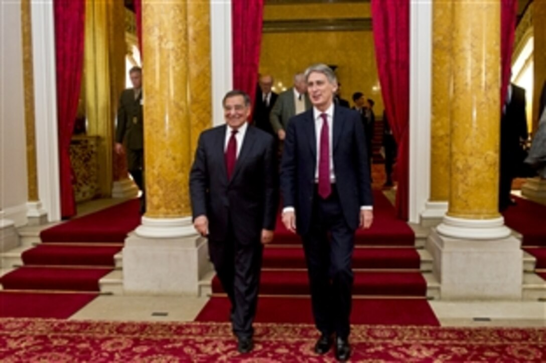 U.S. Defense Secretary Leon E. Panetta walks with British Defense Secretary Philip Hammond in London, Jan. 19, 2013. Panetta is on a six-day trip to Europe to visit with defense counterparts and troops.