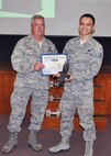 Senior Airman Anthony Francia, 919th Maintenance Squadron, receives his award as 2012 Airman Maintenance Professional of the Year from Col. Kenneth Honaker, 919th Maintenance Group commander. (U.S. Air Force photo/Dan Neely)

