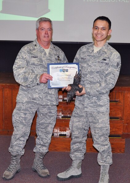 Senior Airman Anthony Francia, 919th Maintenance Squadron, receives his award as 2012 Airman Maintenance Professional of the Year from Col. Kenneth Honaker, 919th Maintenance Group commander. (U.S. Air Force photo/Dan Neely)

