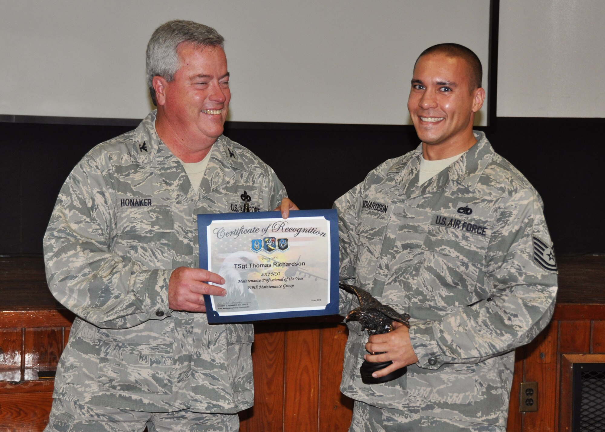 Tech. Sgt. Thomas Richardson, 919th Aircraft Maintenance Squadron, receives his award as 2012 NCO Maintenance Professional of the Year from Col. Kenneth Honaker, 919th Maintenance Group commander. (U.S. Air Force photo/Dan Neely)