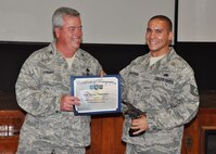 Tech. Sgt. Thomas Richardson, 919th Aircraft Maintenance Squadron, receives his award as 2012 NCO Maintenance Professional of the Year from Col. Kenneth Honaker, 919th Maintenance Group commander. (U.S. Air Force photo/Dan Neely)