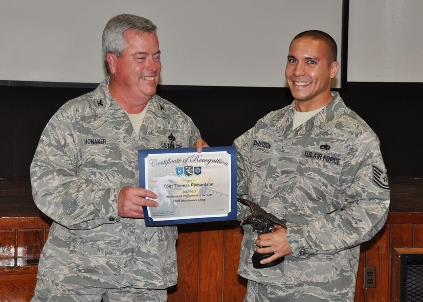 Tech. Sgt. Thomas Richardson, 919th Aircraft Maintenance Squadron, receives his award as 2012 NCO Maintenance Professional of the Year from Col. Kenneth Honaker, 919th Maintenance Group commander. (U.S. Air Force photo/Dan Neely)