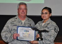 Master Sgt. Flor Contreras, 919th Maintenance Operations Flight, receives her award as 2012 Senior NCO Support Professional of the Year from Col. Kenneth Honaker, 919th Maintenance Group commander. (U.S. Air Force photo/Dan Neely)

