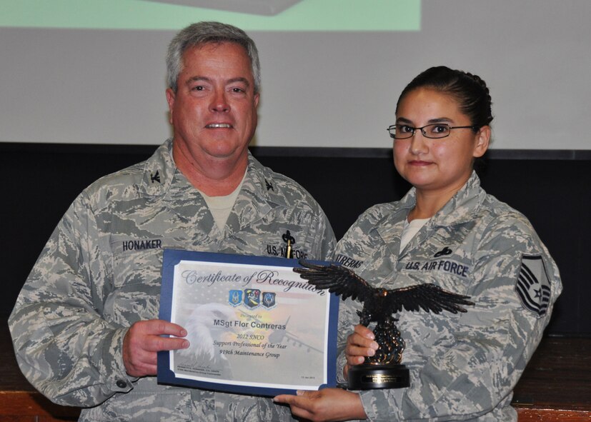Master Sgt. Flor Contreras, 919th Maintenance Operations Flight, receives her award as 2012 Senior NCO Support Professional of the Year from Col. Kenneth Honaker, 919th Maintenance Group commander. (U.S. Air Force photo/Dan Neely)
