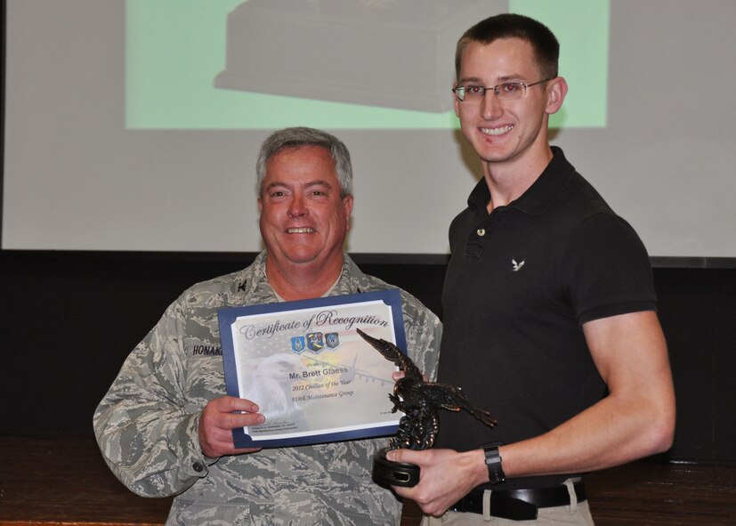 Brett Glaess, 919th Maintenance Group, receives his award as 2012 Civilian of the Year from Col. Kenneth Honaker, 919th MXG commander. (U.S. Air Force photo/Dan Neely)