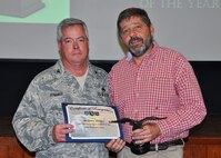 Darrin Nicely receives his award as 2012 Outstanding Support Person of the Year from Col. Kenneth Honaker, 919th Maintenance Group commander. (U.S. Air Force photo/Dan Neely)