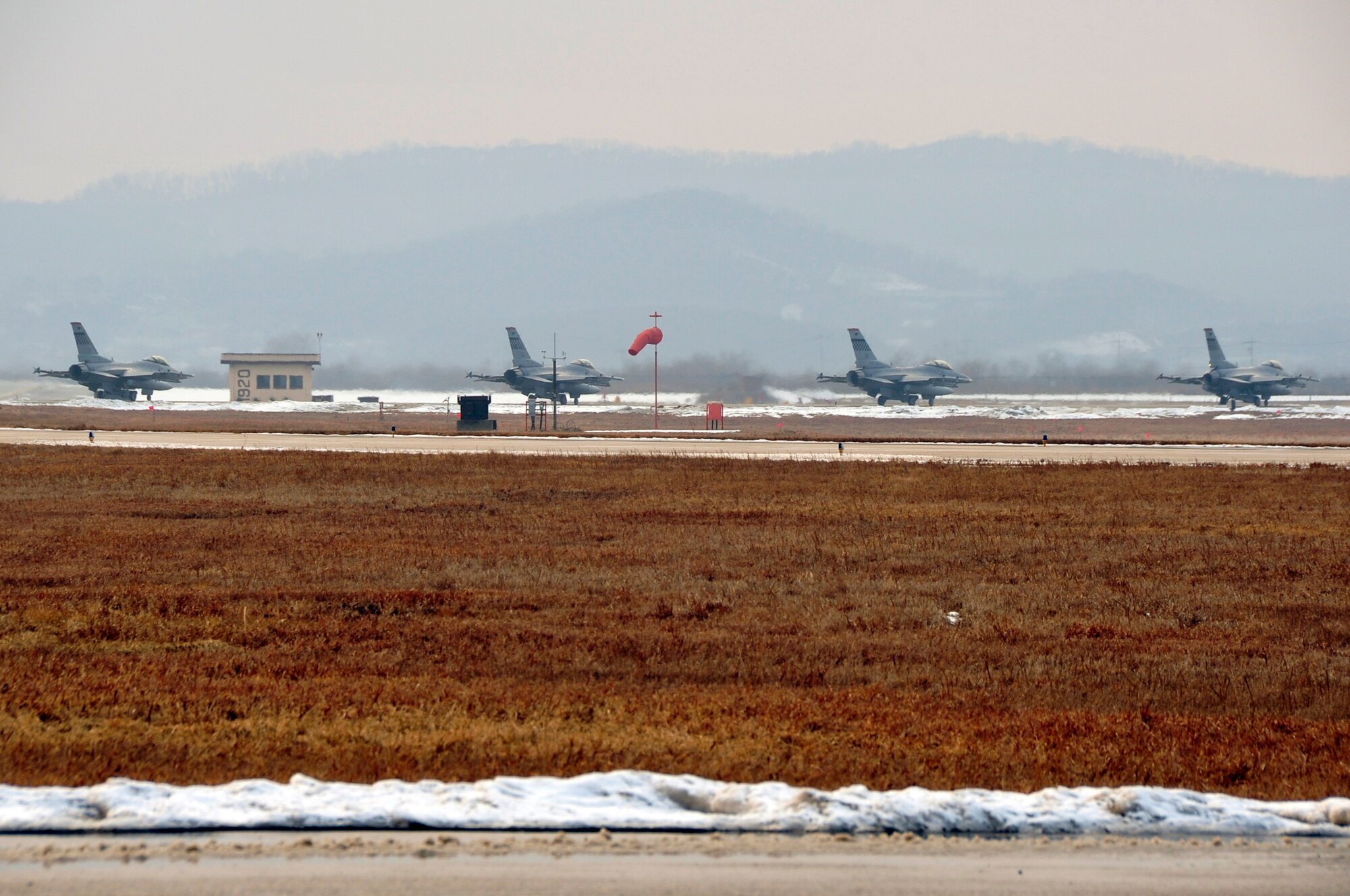 F-16 Fighting Falcons prepare to take off for combat sorties during exercise Beverly Midnight 13-01 at Osan Air Base, Republic of Korea, Jan. 16, 2013. This was the first simulated wartime contingency exercise executed in 2013 that will test the base’s ability to defend and execute the mission in a heightened state of readiness. Osan’s Airmen provide combat ready forces for close air support, air strike control, counter air, interdiction, theater airlift, and communications in the defense of the Republic of Korea. (U.S. Air Force photo/Airman 1st Class Alexis Siekert)